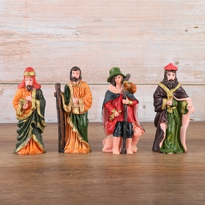 Macro detail of hand-painted resin nativity figurines with gold accents and vintage colors