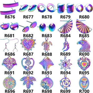 Detailed grid of 25 rainbow crystal water drop and angel wing charms for DIY jewelry making
