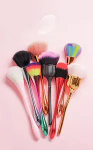 Detailed overhead view of assorted tulip-shaped makeup brushes with metallic finishes