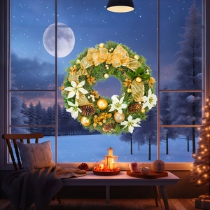 Christmas wreath with gold ribbons and pine cones displayed on a snowy window