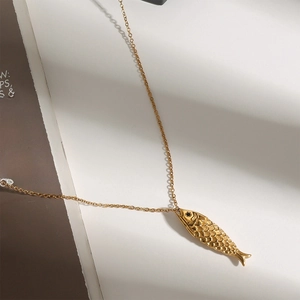 18k gold plated stainless steel fish pendant necklace with detailed scales on white background