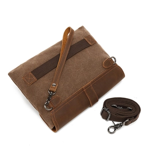 Vintage brown canvas and leather clutch bag with adjustable shoulder strap and wristlet