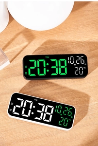 Detail view of 9-inch LED digital clocks in black and white on a natural wooden desk