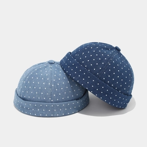 Detail of vintage denim docker hats in light and dark blue with white polka dot patterns