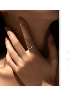 Close-up of S925 sterling silver olive branch ring on finger with soft sunlight