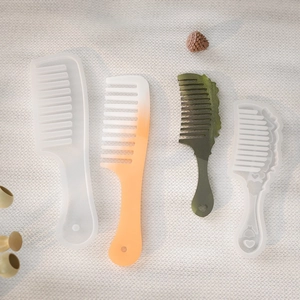 Handmade DIY silicone comb molds with gradient resin finished products on white fabric