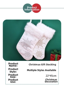 Detail of white Christmas stockings with plush faux fur cuff and gold snowflake embroidery