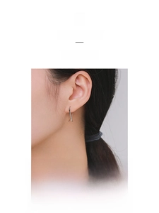 Close-up of minimalist S925 sterling silver earrings with a geometric cross line design