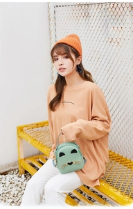 Detail of mint green cat-themed mini crossbody bag with cute 3D ears and metal whiskers
