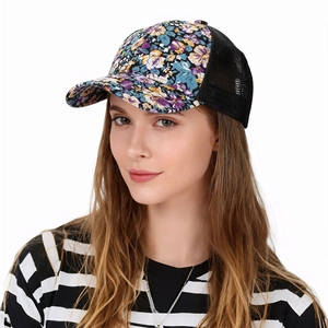Close-up of floral mesh trucker hat featuring breathable black netting and colorful patterns