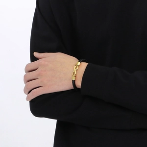 Men's black braided leather bracelet with golden infinity symbol and magnetic clasp