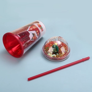 Detailed view of Christmas straw cup with festive tree lid and golden sequins