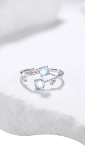 Detailed close-up of 925 silver vine ring with blue moonstone and zircon on white stone