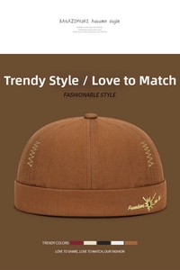 Detailed close-up of brown cotton docker hat with yellow embroidery and Freedom logo
