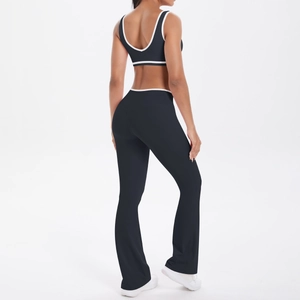 Detail of cross high waist flare yoga pants and crop top with white contrast piping