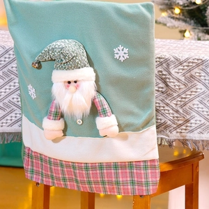 Close-up of mint green Christmas chair cover with 3D Santa Claus and snowflake detail