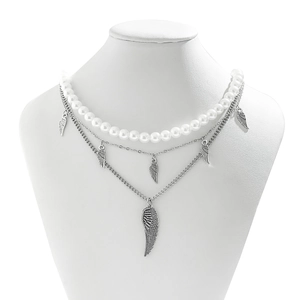 Detail of multi-layered necklace with white pearls and silver wing pendants on a bust