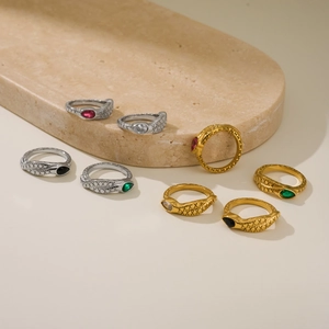 Detailed close-up of 18k gold plated snake rings with marquise zircons and cross texture
