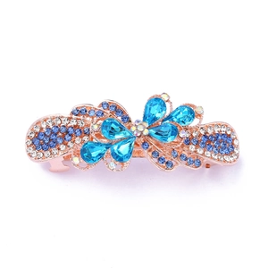 Detailed view of a rose gold hair clip with sparkling blue and clear crystal flowers
