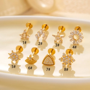 F136 Titanium snowflake and star cartilage earrings with zircon on a ceramic tray
