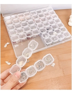 Detail view of a 28-grid clear acrylic jewelry box with individual storage compartments