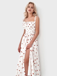 Detail of square neckline with ruffle trim and strawberry print on white dress