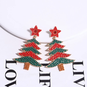 Detailed view of handmade beaded Christmas tree earrings in festive red and green colors