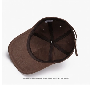 Internal view showing black reinforced seams and adjustment strap of the brown baseball cap