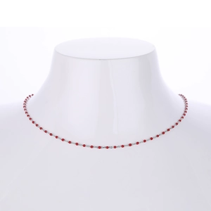 Detailed view of an S925 sterling silver necklace with red beads on a white mannequin