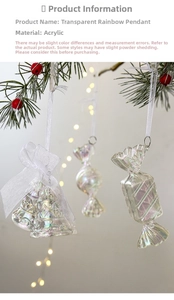 Close-up of colorful acrylic Christmas bell and candy charms hanging on a pine branch
