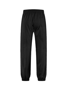 Detail of black drawstring linen pants with textured pleats and elastic cuffs on back view