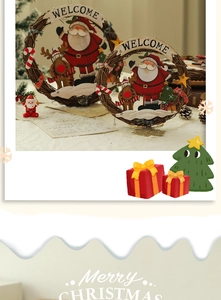 Detail view of woven rattan Christmas welcome wreaths with Santa and reindeer motifs