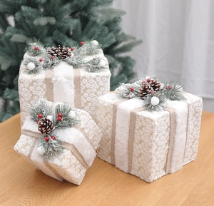 Three-piece Christmas gift box set with white snowflakes, pine cones, and red berries decor