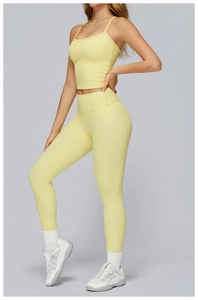 Detail of light yellow brushed yoga vest fabric texture and slim fit athletic design