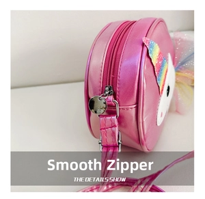 Detail showing smooth metal zipper and pink metallic faux leather on unicorn bag
