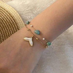 Double-layered gold bracelet with seashell fishtail pendant and blue natural stones