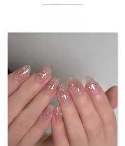 Detail of pink gradient press-on nails with silver glitter and colorful heart sequins