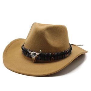 Detail of camel wool fedora hat featuring ethnic woven band and metal bull head ornament