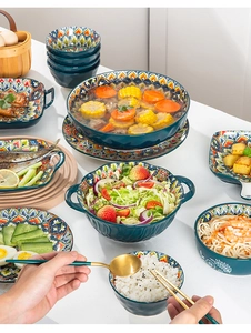 Top view of bohemian ceramic tableware set with colorful patterns on a dining table