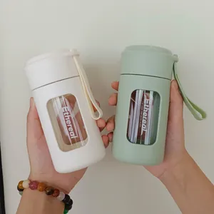 Portable heat-resistant glass water bottle with tea infuser and carrying strap