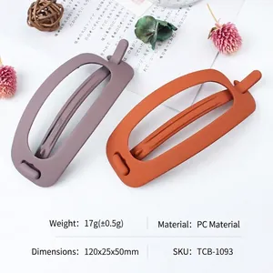 Matte finish hollow oval hair clips in purple and orange colors for ponytails