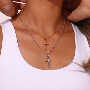 Gold and silver layered cross pendant necklaces with zircon bead on model