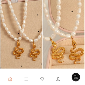 Detailed macro view of natural freshwater pearls and golden snake pendant on necklace