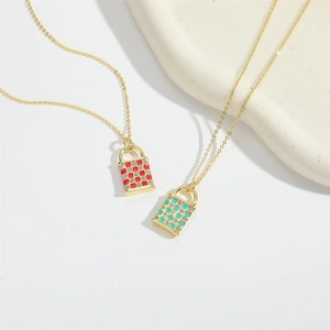Minimalist gold chain necklace featuring heart-shaped enamel lock pendants with rhinestones