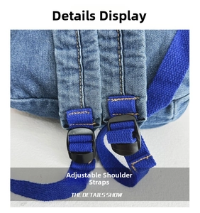 Detail view of denim backpack showing blue strap with adjustable plastic buckle