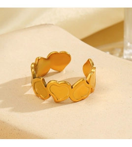 Macro detail of 18K gold plated heart wrap ring with adjustable open band design