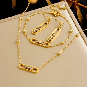 Gold-plated stainless steel jewelry set with movable crystals on elegant display