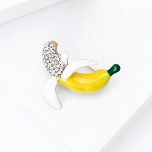 Close-up of cute banana brooch featuring yellow enamel and sparkling rhinestones