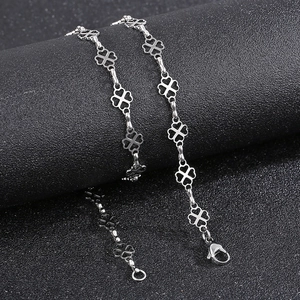 Detailed shot of silver titanium four-leaf clover chain with hollowed lucky motifs