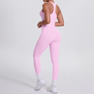 Detail view of pink yoga leggings side pockets and high-waisted seamless fabric texture